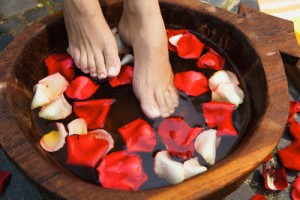 Feet in water with rose petals